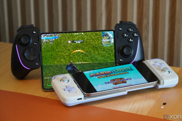 Person playing a popular mobile game on a smartphone while a Nintendo Switch or PSP lies on the table.