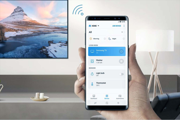 Smartphone controlling a smart TV and sound system via a remote control app.