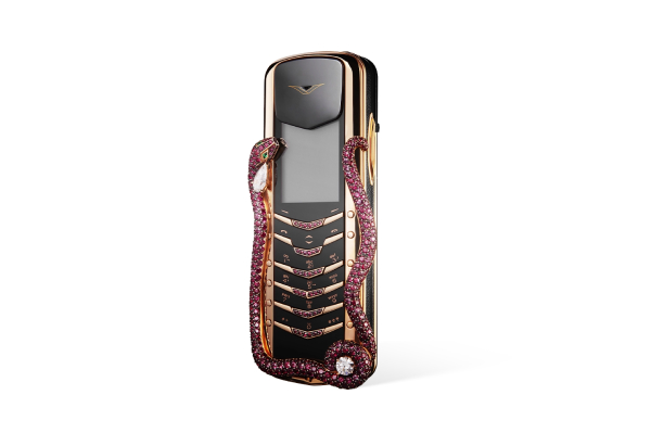Vertu luxury phone with gold body, rubies, and diamond accents.