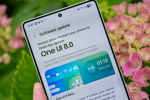 Samsung smartphone showing One UI 8.0 software update screen in hand